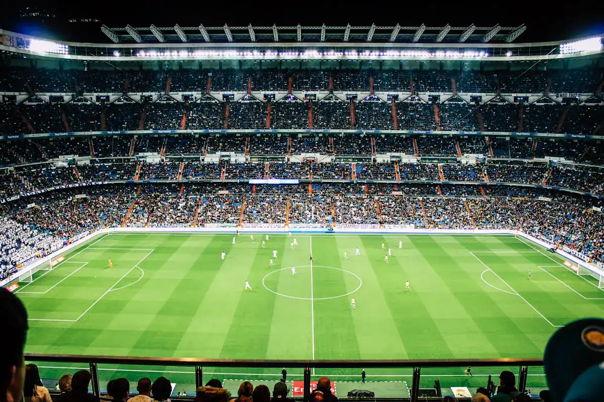 Estádio de futebol iluminado durante jogo transmitido em 4K